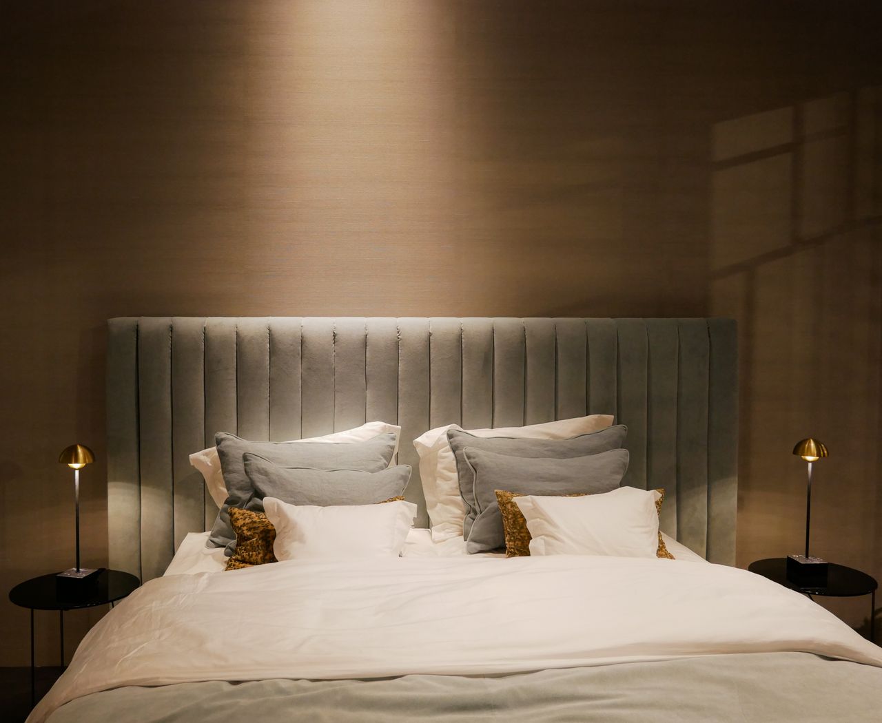 Stylish bedroom setup featuring a plush bed and elegant bedside lamps.